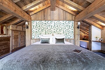 A bedroom with a bed and a book on it