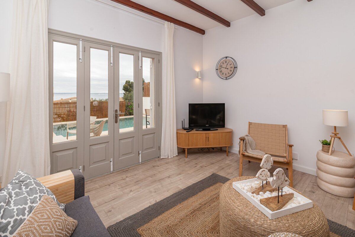 A living room with a television and a clock on the wall