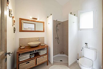 A bathroom with a toilet a sink and a mirror