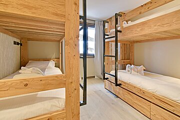 A bedroom with bunk beds and a window