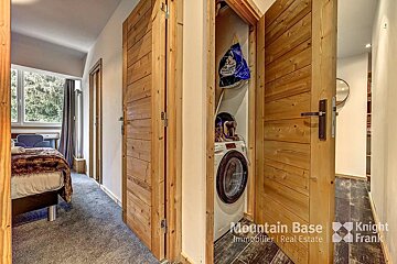 A room with a washer and dryer and a sign that says mountain base