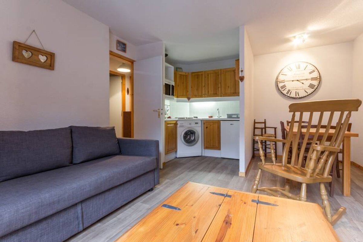 A living room with a couch and a rocking chair