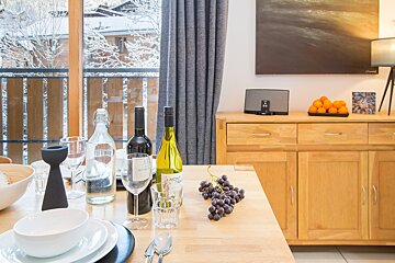 A bottle of amont pinot sits on a wooden table