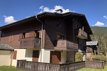 A house with a balcony and a fence in front of it