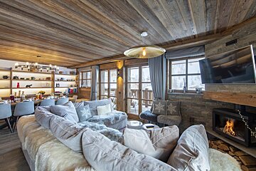 A living room with a large couch and a fireplace