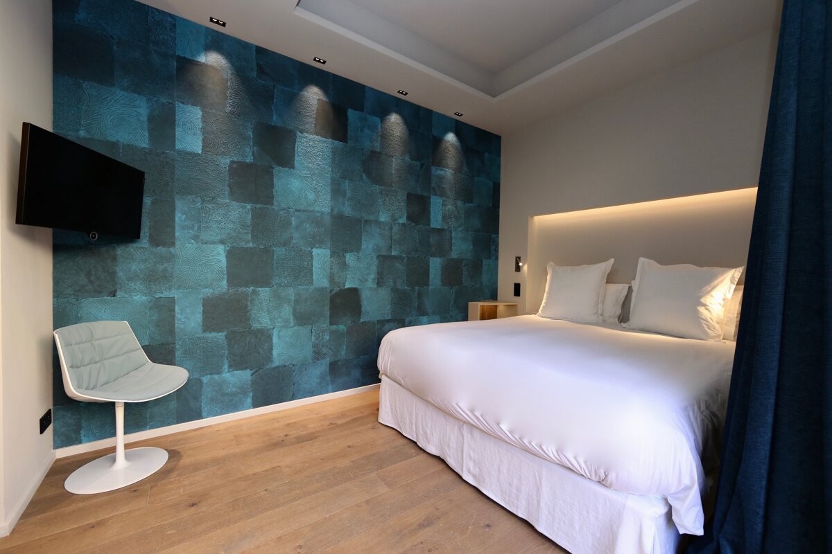 A bedroom with a blue wall and a bed