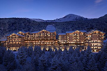 A large building in the middle of a snowy forest