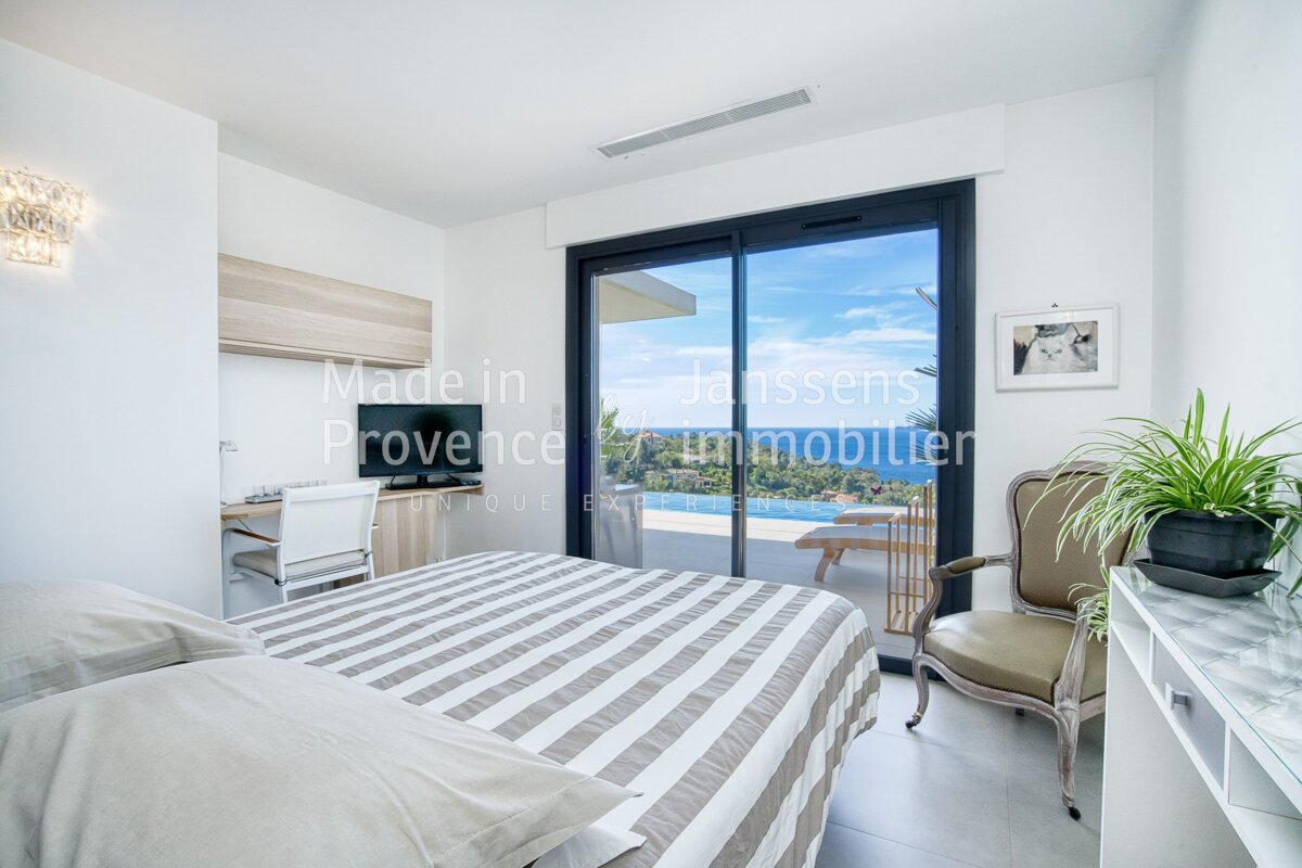 A bedroom with a sliding glass door that says made in provence