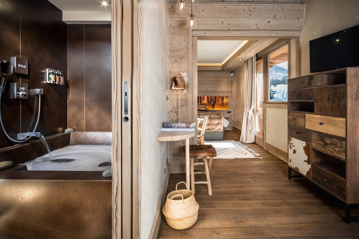 A bathroom with a bathtub and a dresser