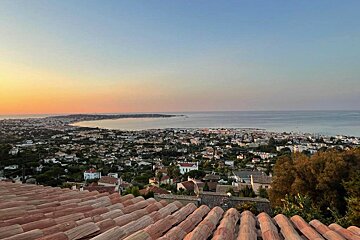 A view of a city with the ocean in the background