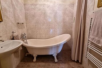 A bathroom with a claw foot bathtub and a sink