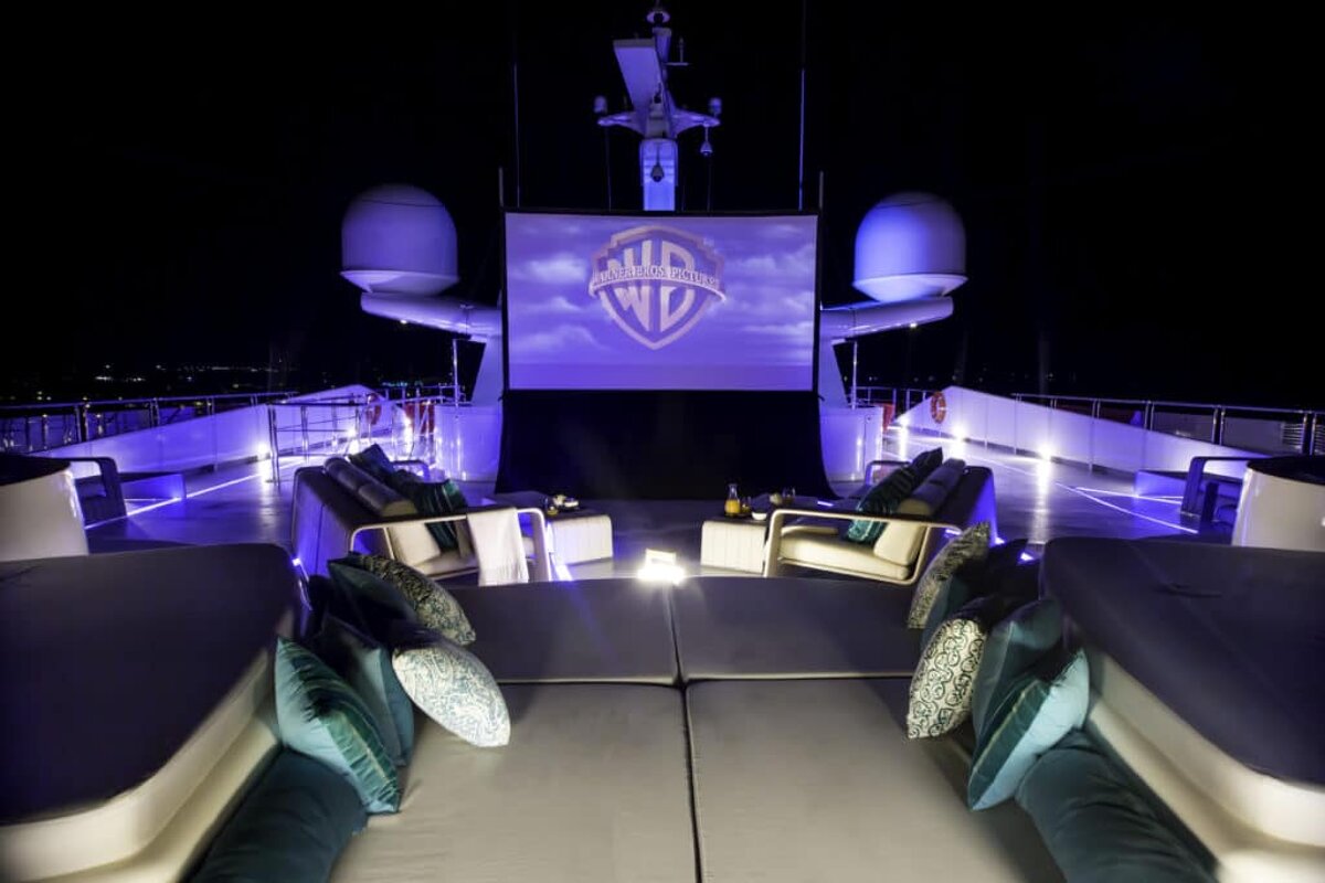 A large screen displays a logo for warner bros