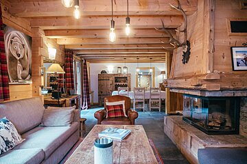 A living room with a couch a chair and a fireplace