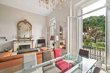 A living room with a fireplace and a dining table