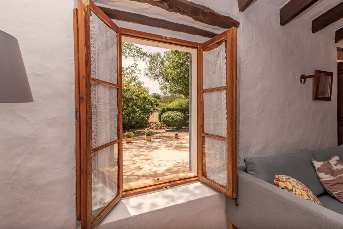 An open window with a couch in front of it