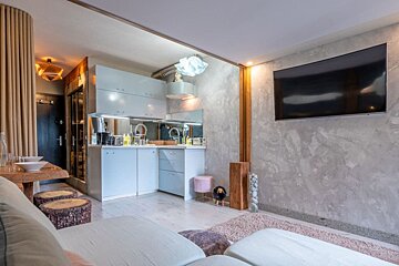 A living room with a couch and a flat screen tv