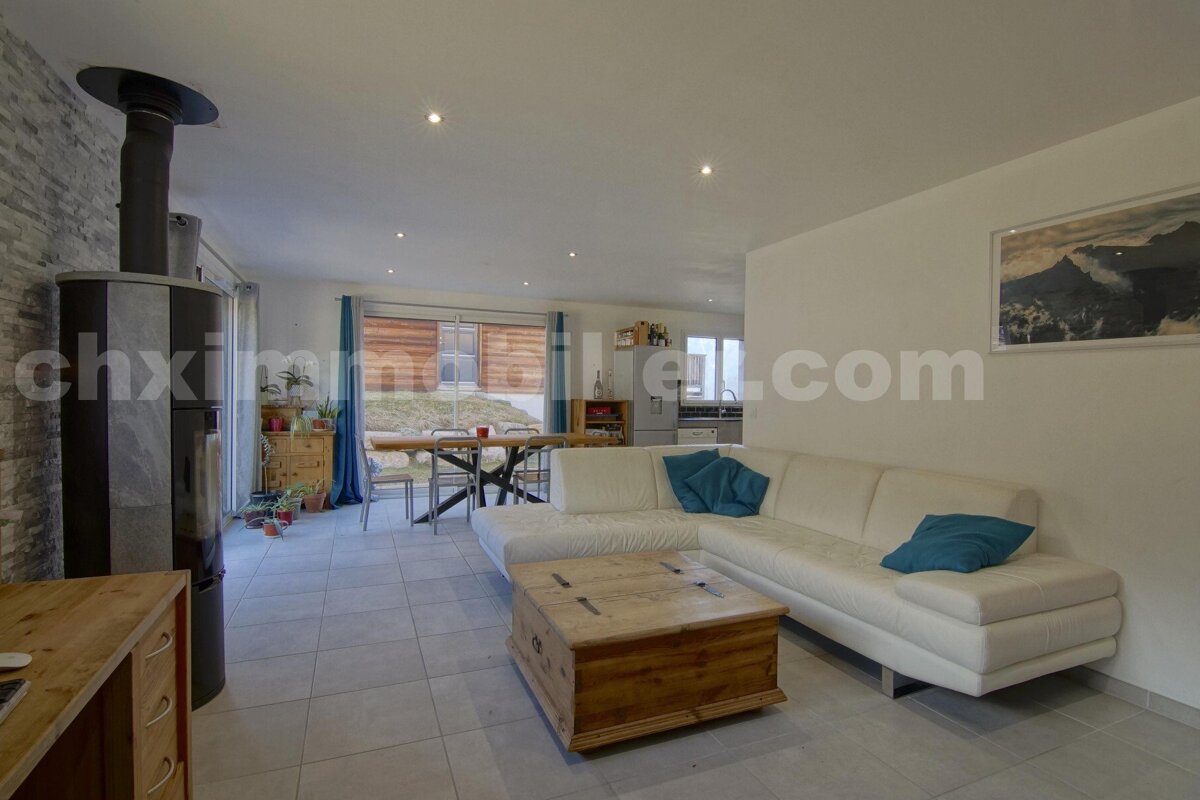 A living room with a couch and a coffee table and the website chximmobilier.com