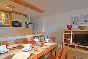 A dining room table with plates and cups on it