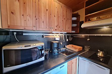 A kitchen with a microwave and a coffee maker