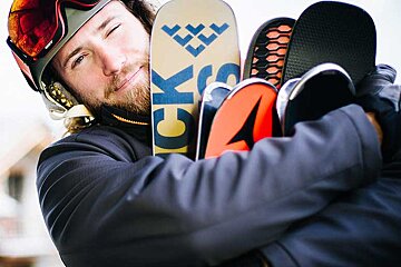 A man holding a snowboard that says ck on it