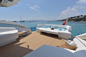 A boat with a couch and a basket on the deck
