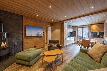 A living room with a couch and a flat screen tv