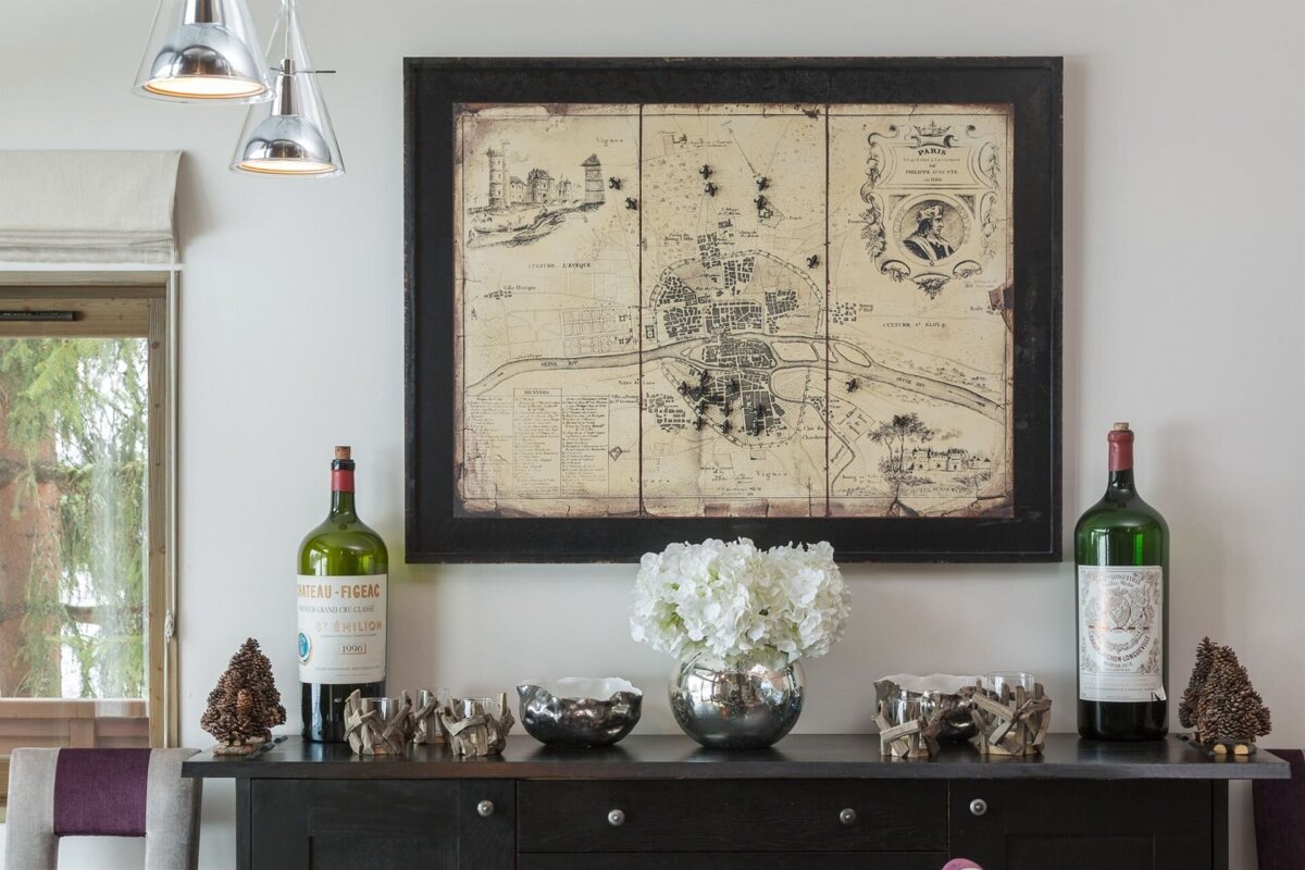 A bottle of chateau pichon sits on a dresser