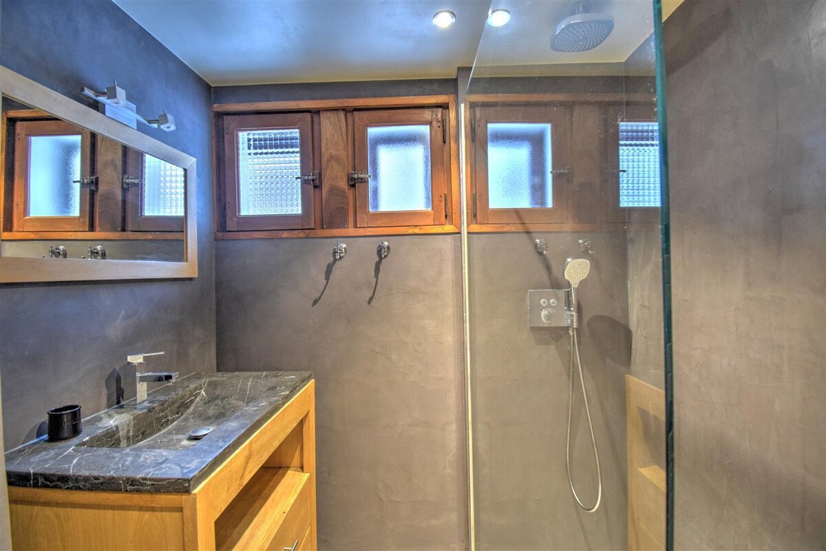 A bathroom with a sink and a walk in shower