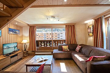 A living room with a couch and a flat screen tv