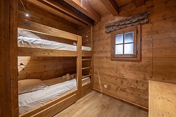 A bathroom with a sink and a shower stall