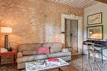 A living room with a stone wall and a couch