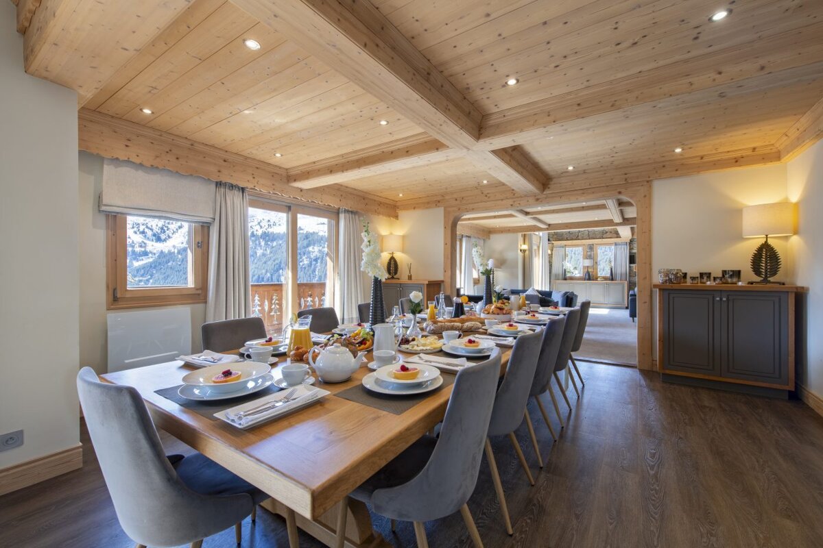 A dining room table with plates of food on it