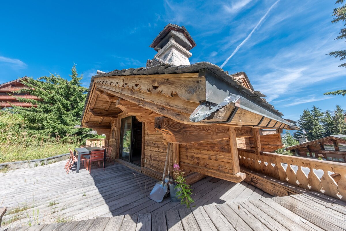 A wooden deck with a table and chairs on it