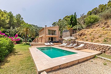 A large house with a large swimming pool in front of it