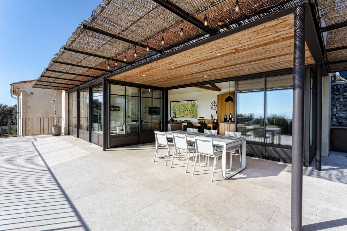 A patio with a table and chairs under a canopy