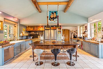 A kitchen with a painting of two women on the ceiling