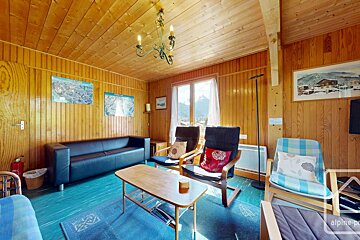 A living room with a couch chairs and a coffee table