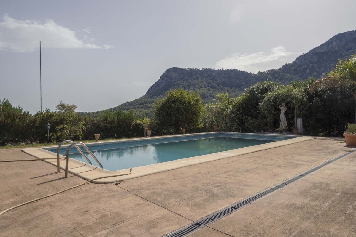 A large swimming pool with a mountain in the background