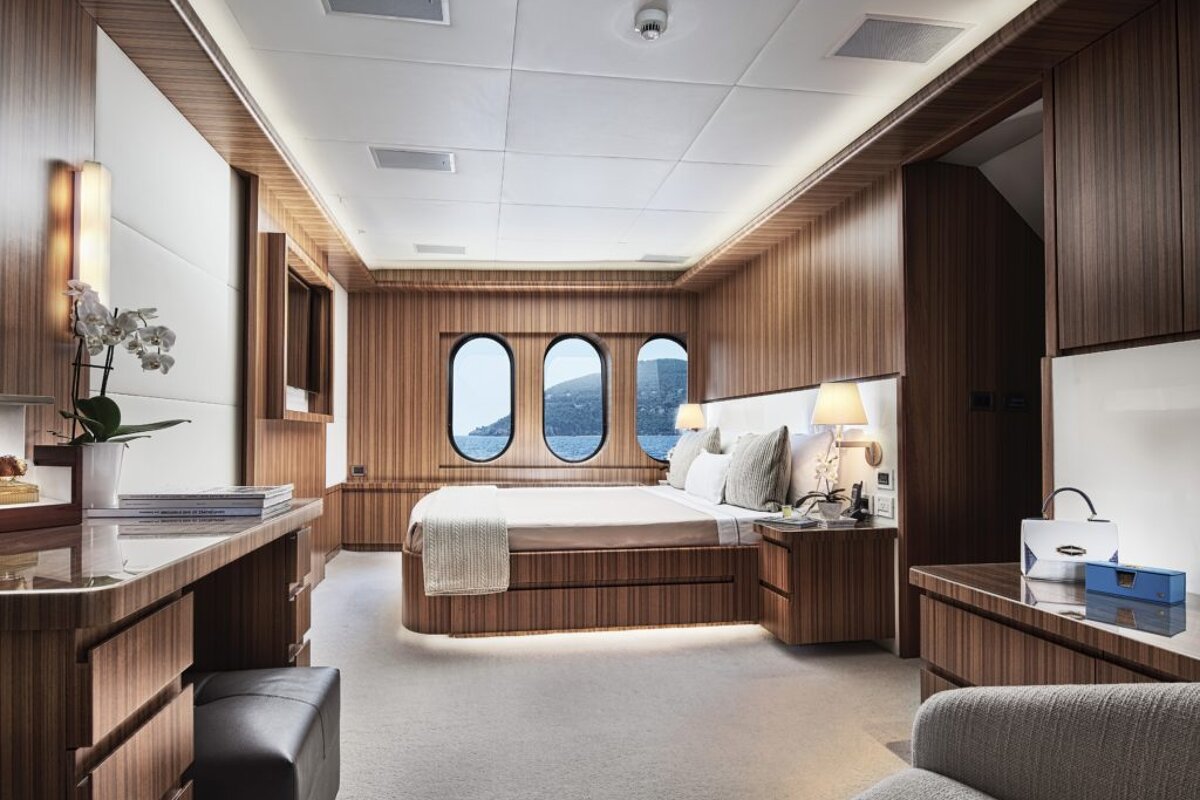 A bedroom with a large bed and two windows