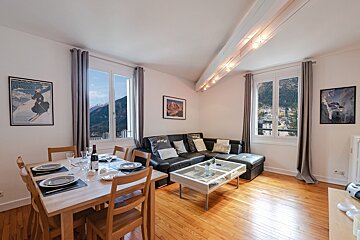 A living room with a couch and a dining table