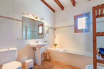 A bathroom with a toilet a sink and a bathtub