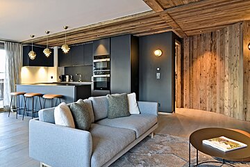 A living room with a couch and a book on a table