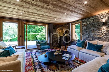 A living room with a couch and a table and a sign that says ten80 holidays