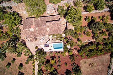 An aerial view of a house with a swimming pool