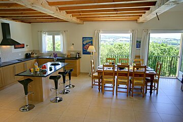 A kitchen with a table and chairs and a sign that says ducati