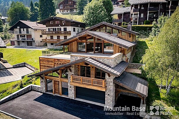 An aerial view of a mountain base real estate property