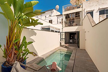 A small swimming pool in the backyard of a house