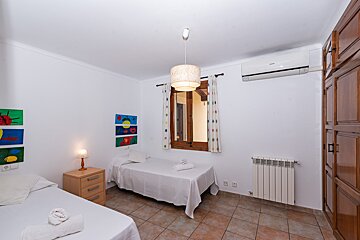 A bedroom with two beds and a samsung air conditioner