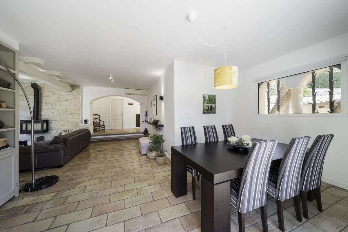 A dining room with a black table and chairs