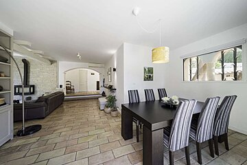 A dining room with a black table and chairs